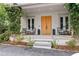 Cozy front porch with double doors, charming seating, and beautiful landscape at 110 3Rd St, Fayetteville, GA 30214
