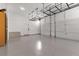 Spacious garage featuring clean epoxy flooring, overhead rack storage, and ample space for vehicles at 110 3Rd St, Fayetteville, GA 30214
