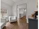 Sitting area with two white armchairs, and hardwood floors, leading to hallway at 110 3Rd St, Fayetteville, GA 30214