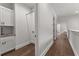 Hallway with hardwood floors leading to the laundry room with custom cabinets and sink at 110 3Rd St, Fayetteville, GA 30214