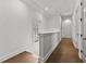 Bright hallway on the second level with hardwood floors and white walls at 110 3Rd St, Fayetteville, GA 30214