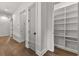 Upstairs hallway with hardwood floors and built-in linen closet at 110 3Rd St, Fayetteville, GA 30214