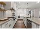 Bright kitchen with stainless steel appliances, white cabinets, and hardwood floors at 110 3Rd St, Fayetteville, GA 30214