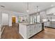Open-concept kitchen with a center island, stainless steel appliances, and wood floors at 110 3Rd St, Fayetteville, GA 30214