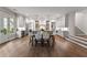 Spacious open kitchen/dining area with white cabinetry, stainless steel appliances, and wood flooring at 110 3Rd St, Fayetteville, GA 30214