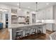 Spacious kitchen featuring white cabinets, a large island with seating, and modern lighting fixtures at 110 3Rd St, Fayetteville, GA 30214