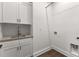 A well-equipped laundry area featuring custom cabinets and a convenient utility sink at 110 3Rd St, Fayetteville, GA 30214