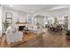 Open-concept living room with hardwood floors, a fireplace, and a view into the dining and kitchen areas at 110 3Rd St, Fayetteville, GA 30214