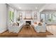 Inviting living room featuring white sofas, a stone fireplace, and an area rug over hardwood floors at 110 3Rd St, Fayetteville, GA 30214