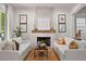 Bright living room featuring sofas, a stone fireplace, and a jute rug at 110 3Rd St, Fayetteville, GA 30214
