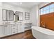 Luxurious main bathroom featuring a soaking tub, separate shower, and double sink vanity at 110 3Rd St, Fayetteville, GA 30214
