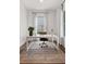 Cozy office space with a white desk, leather chair, and natural light from the window and French doors at 110 3Rd St, Fayetteville, GA 30214