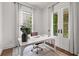 Bright office space with white desk, modern decor, and French doors leading to an outdoor area at 110 3Rd St, Fayetteville, GA 30214