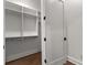 Walk-in closet with wood floor, custom built-in shelving and drawers at 110 3Rd St, Fayetteville, GA 30214