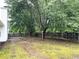 The backyard features a fence, a patio, and mature trees at 1255 Summit Point Ln, Snellville, GA 30078