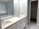 Bathroom featuring double sinks, quartz countertop, and walk-in closet beyond the door creating a serene space at 1255 Summit Point Ln, Snellville, GA 30078
