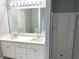Bathroom with double sinks, quartz countertop, and a bright white tiled shower for a clean, modern look at 1255 Summit Point Ln, Snellville, GA 30078