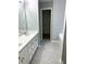 Bathroom featuring double sinks, quartz countertop, and a walk-in closet creating a tranquil and spacious retreat at 1255 Summit Point Ln, Snellville, GA 30078