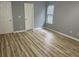 This bedroom features wood flooring, neutral paint, and a window at 1255 Summit Point Ln, Snellville, GA 30078