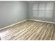 Cozy bedroom with wood floors, gray walls, and a window allowing natural light to illuminate the space at 1255 Summit Point Ln, Snellville, GA 30078