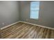 This bedroom features wood flooring, neutral paint, and a window at 1255 Summit Point Ln, Snellville, GA 30078