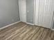This bedroom features wood flooring, a standard closet, and neutral paint at 1255 Summit Point Ln, Snellville, GA 30078