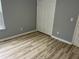 This bedroom features wood flooring, neutral paint, and a closet at 1255 Summit Point Ln, Snellville, GA 30078
