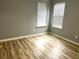 Bedroom with light-colored wood floors, two windows, and natural light, for a comfortable living space at 1255 Summit Point Ln, Snellville, GA 30078