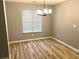 Bright dining room featuring wood floors, a modern light fixture, and a window providing ample natural light at 1255 Summit Point Ln, Snellville, GA 30078