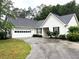 Charming single-story home with white siding, black shutters, and a two-car garage at 1255 Summit Point Ln, Snellville, GA 30078