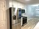 Kitchen featuring stainless steel appliances, modern refrigerator, and breakfast nook at 1255 Summit Point Ln, Snellville, GA 30078