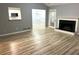Living room with fireplace, view into kitchen and breakfast nook, and wood floors at 1255 Summit Point Ln, Snellville, GA 30078