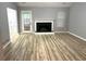 Spacious living room with fireplace, wood floors, gray walls, and natural light at 1255 Summit Point Ln, Snellville, GA 30078