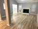 Open-concept living room with fireplace, wood floors, and a view into other rooms at 1255 Summit Point Ln, Snellville, GA 30078