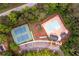 Aerial view of community pool, tennis courts, playground, parking, and surrounding mature trees at 2759 Beddington Way, Suwanee, GA 30024