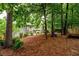 This private backyard features beautiful foliage and mature trees at 2759 Beddington Way, Suwanee, GA 30024