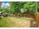 Fenced backyard with a patio, manicured landscaping, and mature trees at 2759 Beddington Way, Suwanee, GA 30024