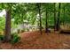 The property features a spacious backyard with trees that provide ample shade and privacy at 2759 Beddington Way, Suwanee, GA 30024