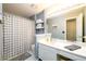 Well-lit bathroom featuring a white vanity with ample counter space and a patterned shower curtain at 2759 Beddington Way, Suwanee, GA 30024