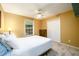 Bedroom featuring neutral walls, carpeted floors, a ceiling fan, and a large window at 2759 Beddington Way, Suwanee, GA 30024