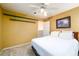 Bedroom with light-yellow walls, ceiling fan, and built-in wall shelving at 2759 Beddington Way, Suwanee, GA 30024