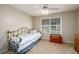 Cozy bedroom with blue-striped bed, ceiling fan, and bright natural light from a window at 2759 Beddington Way, Suwanee, GA 30024