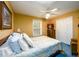 Well-lit bedroom with a ceiling fan and double closet at 2759 Beddington Way, Suwanee, GA 30024