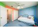 Bright bedroom with blue accent wall, closet and bed with striped bedding at 2759 Beddington Way, Suwanee, GA 30024