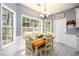 Cozy breakfast nook filled with light features wainscotting and a lovely chandelier at 2759 Beddington Way, Suwanee, GA 30024
