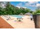 A large community pool area with lounge chairs, umbrellas, and tables for residents' enjoyment at 2759 Beddington Way, Suwanee, GA 30024