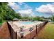 Spacious community pool area with lounge chairs, tables, and lush landscaping, ideal for summer relaxation at 2759 Beddington Way, Suwanee, GA 30024