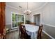 Bright dining room featuring hardwood floors, a chandelier, and large windows at 2759 Beddington Way, Suwanee, GA 30024