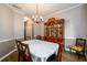 Formal dining room featuring an elegant chandelier and a large wooden china cabinet at 2759 Beddington Way, Suwanee, GA 30024
