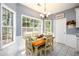 Cozy dining area featuring a chandelier, large windows, and wainscoting at 2759 Beddington Way, Suwanee, GA 30024